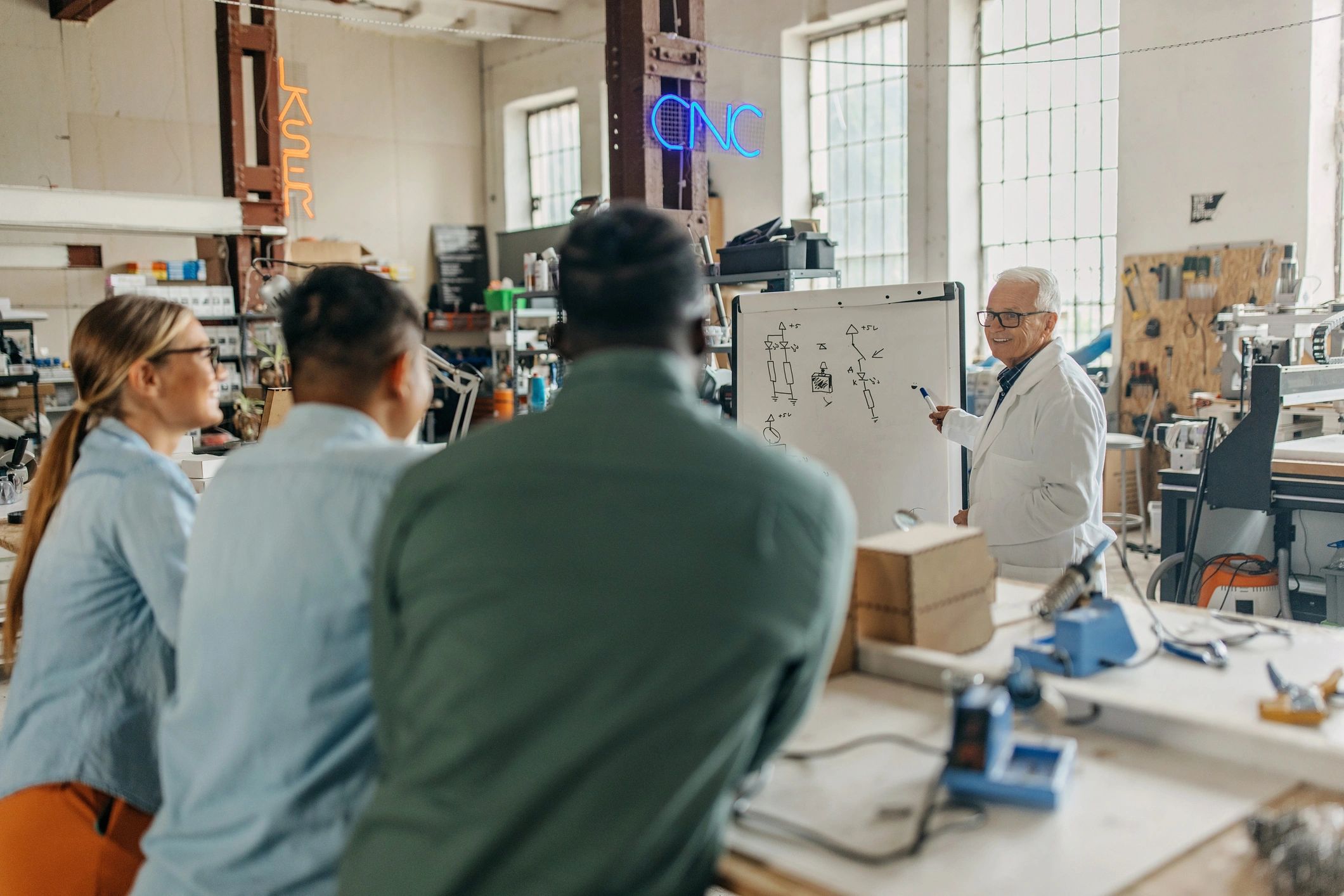 Professor teaching electronics to students in class