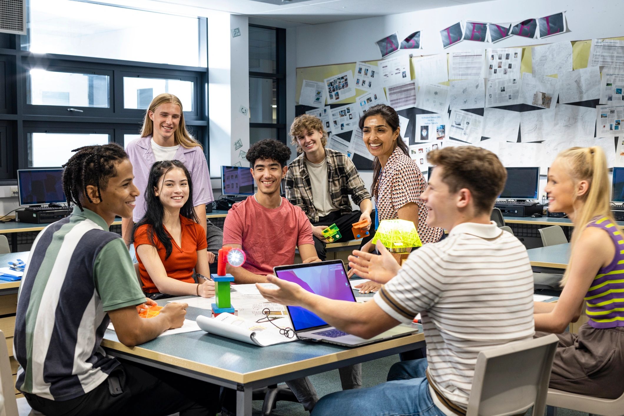 Students and teacher collaborating in a technical classroom