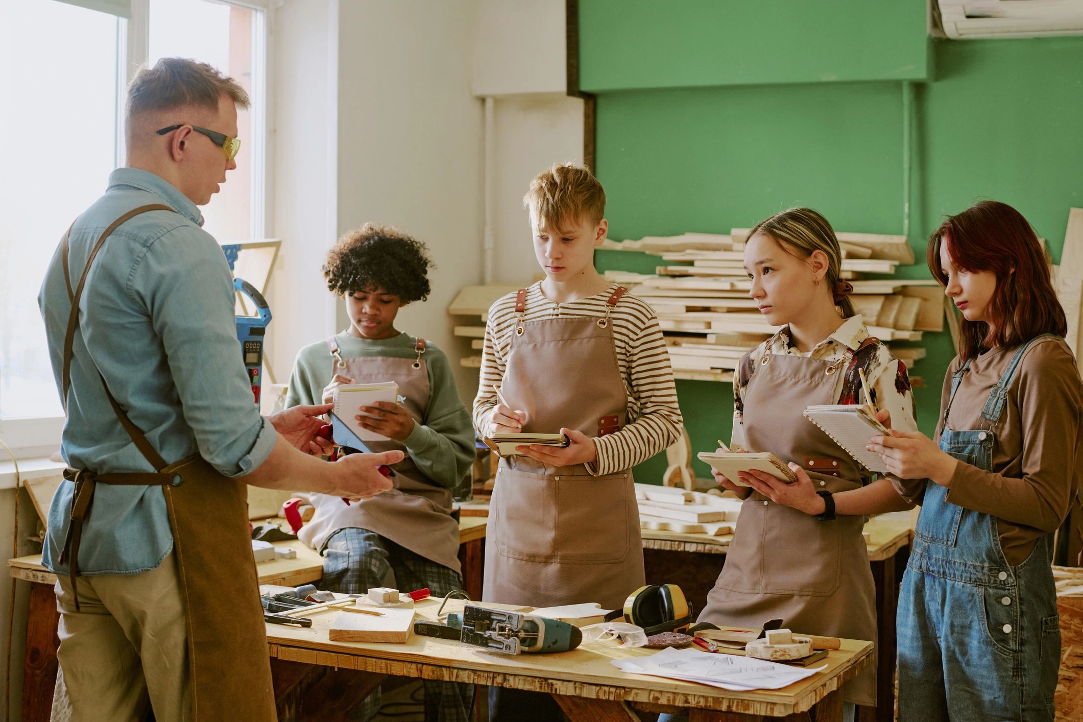 Instructor guiding students in a technical workshop
